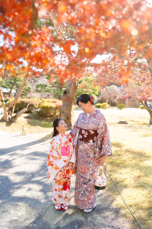 Singaporean mother and daughter in kimono under autumn leaves at Hamarikyu Gardens, Tokyo