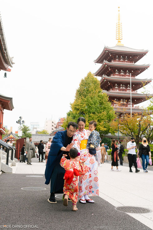 Singaporean family with children in colorful kimono enjoying their visit at Sensoji Temple, with the iconic five-storied pagoda in the background