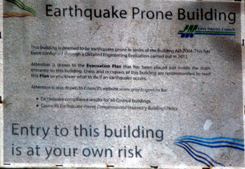 'Earthquake Prone Building' sign on wharfside building in Greymouth, Westland