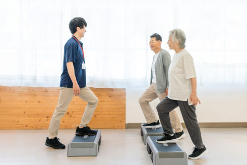 トレーナーに教わりながら運動をしている人