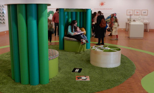 A photo of the galleries in Eric Carle Museum showing seating for parents reading to their children