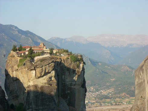 Holy Trinity Monastery in Meteora, Greece is reached by the tiny cable car to left