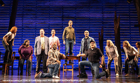The Cast of Come from Away singing on stage