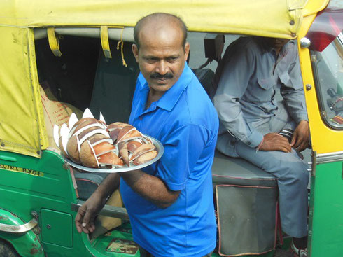 2013 New Delhi vendor sells slices of fresh coconut to drivers in stalled traffic