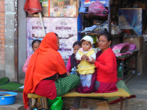 2013 A family group sits in front of a shop on the streets of Bhaktapur, Nepal