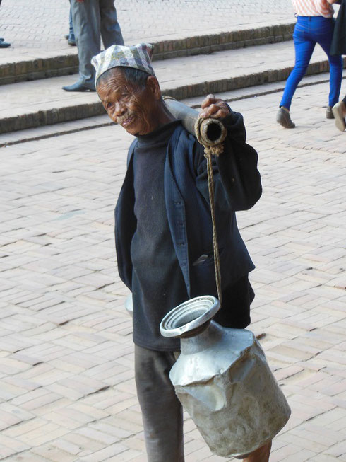 2013 A local man carrying jugs of milk through Durbar Square in Patan