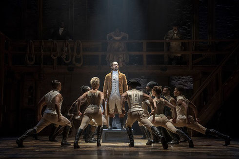 Actors in a dance number on stage in the performance of Hamilton