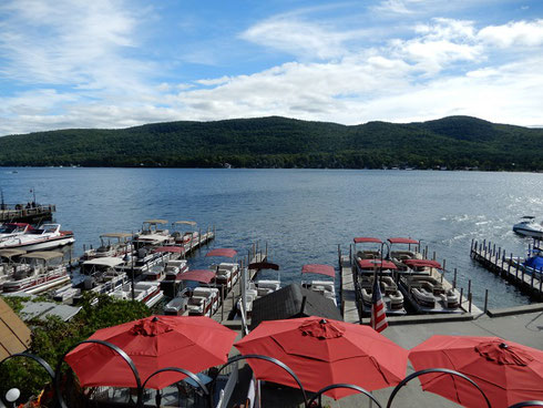 Lake George on a sunny day with red beach umbrellas