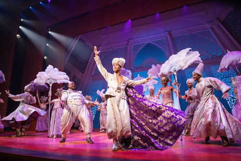 Cast of Aladdin dancing on stage