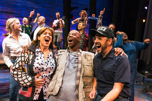 The cast of Come from Away laughing and singing