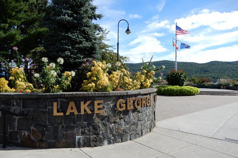 A sign in front of the Lake George Visitor Center - lake beyond