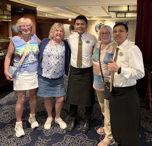 2026 A Group of Adventure Tours Passengers with Waitstaff aboard Norwegian Breakaway
