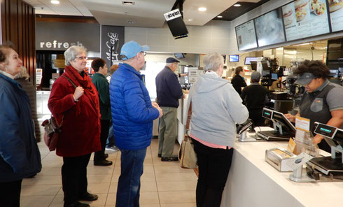 A group of Travelers standing in line for breakfast at McDonald's