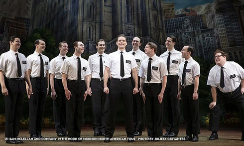 Stage is filled with Mormon Missionaries in white shirts and black ties