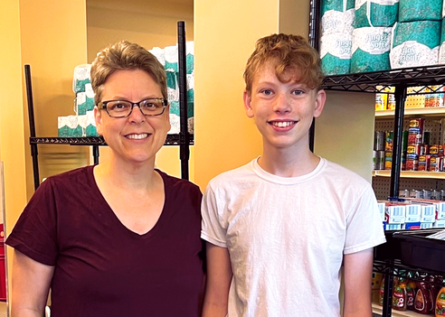 For his b’nai mitzvah project, Elon Katz (right) collected hundreds of personal care items for Jewish Family Service Heldman Family Food Pantry. Here, Elon and his mother, Helisa Katz, take a break from stocking the food pantry shelves with his items.