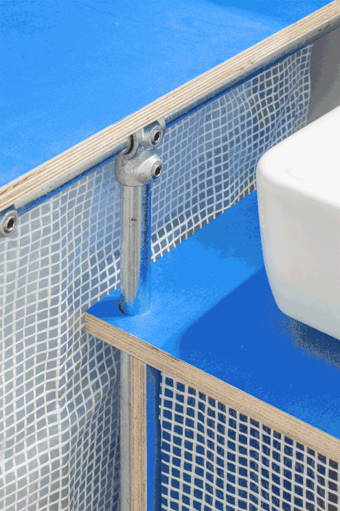 modular bathroom furniture made of colorful painted wood and steel tube connectors. Modern interior design project using the colors of blue and orange.