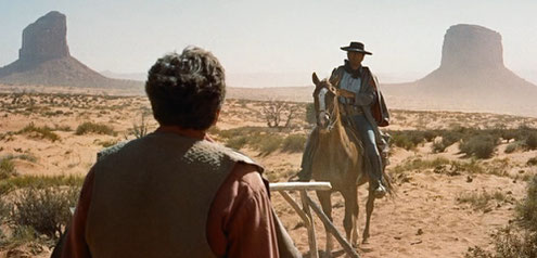 The opening of "The Searchers" in Monument Valley: John Wayne between Gray Whiskers and Mitchell Butte. 