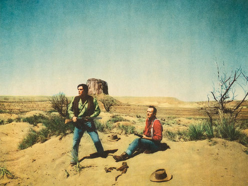 Monument Valley's Mitchell Butte in the background of this scene with John Wayne in "The Searchers".
