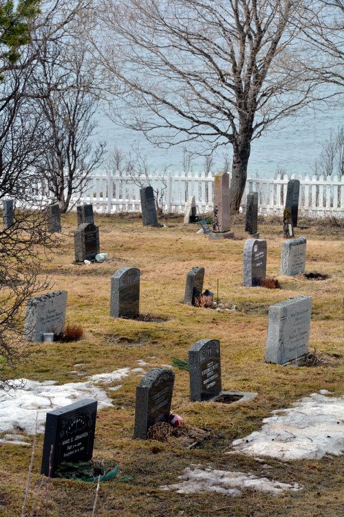 The 'gravlund' - graveyard - near isolated Jøvik on the Kjosen inlet. The gravestone made of polished 'black granite' - a commercial name for the gabbro of which the Lyngen Alps are made.