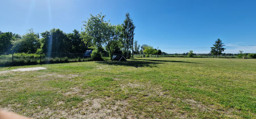Campingplatz und hinter dem Zaun Beginn Parkflächen