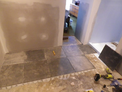 Starting the tiling, lined up off the centre of the shower