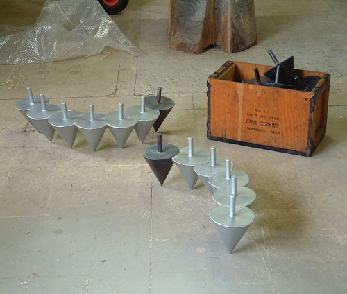 Elke beweging creëert een vorm — foto van het oorspronkelijke sculptuur bestaande uit een reeks metalen kegels, gebruikt als uitgangspunt voor het onderzoek naar vormontwikkeling door verplaatsing en herhaling.