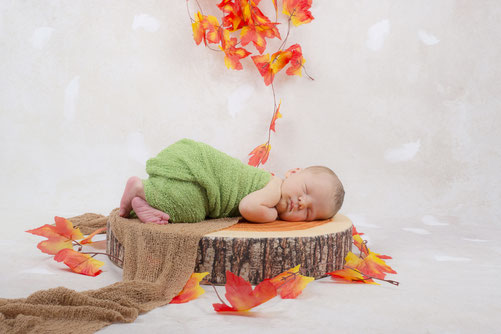 newborn in costume and with flowers