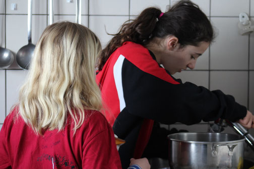 Teilnehmende beim Kochen im Schneesportlager - die Verpflegung ist bei einem Lager natürlich besonders wichtig.