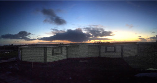 house with no roof but the clouds and a sunset