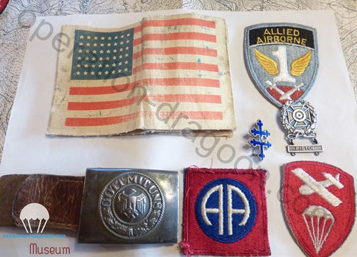 Arm band, Patches, german buckle belt and lorraine cross World War II memorabialia bring back by Gene FRICE. 