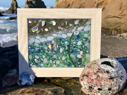 The resin piece with abalone shells found at the beach that morning