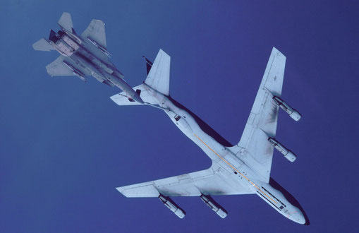 An F-15 approaches a KC-135 flying tanker to refuel.