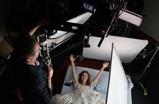Image of elevated camera shooting actress Zoey Deutch waking up in bed, from the movie Before I Fall.