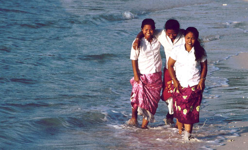 NIcobarese girls take an evening stroll on an island beach, Andaman and Nicobar Islands, India.