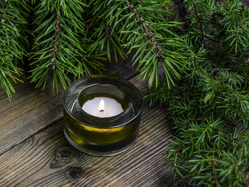 A candle and fir branches at the Freemason's Christmas Concert in Bournemouth.