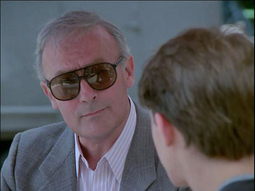 Edward Woodward as Robert McCall in The Equalizer first season episode "Confirmation Day", meeting with a young client who is afraid for his father