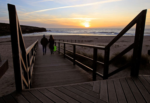Couple walks to the beach on a sunset at Lisandro beach on the Atlantic sea coast of Portugal 40Km North of Lisbon March 20, 2013.