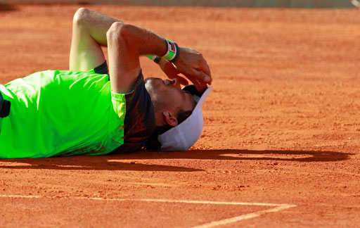 Argentinian tennis player Carlos Berlocq lies on the pitch celebrating his victory after beating Czech Republic Tomas Berdych on the Portugal Open final tennis match at Jamor stadium in Oeiras, outskirts of Lisbon, on May 4, 2014