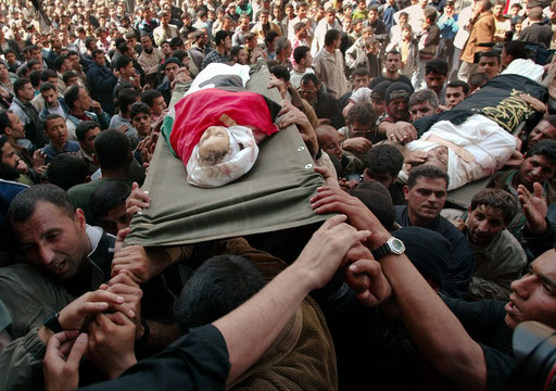 A four year old Palestinian girl Elham al-Assar is carried to the mosque in the Nuseirat refugee camp in the central Gaza Strip during a funeral ceremony March, 2003
