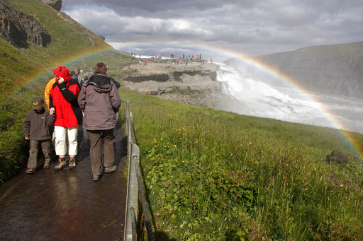 People walk on a corridor to visit a waterfall in Iceland July 24, 2009.