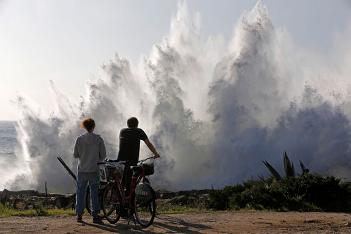 Couple watches the storm waves blowing on the Cascais cliffs on 2014