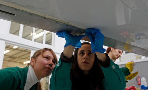 Pupils work on a plane wing on a classroom of aeronautics in the Instituto do Emprego e Formacao Profissional (IEFP) vocational training center in Setubal February 1, 2013.