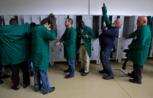 Pupils and teacher (2nd R) dress them selfs to start a classroom of cooling technologies  at the vocational training center of IEFP in Setubal February 1, 2013.