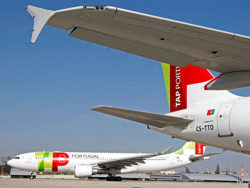 TAP Portugal airlines' Airbus 320 aircraft maneuver behind another Tap Airbus 319 at Lisbon airport March 29, 2012.