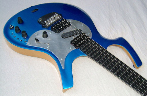 Not only the middle pickup and the pickguard and the 5-way switch were added. Also three parts of the body shape were slightly changed: Both cutaways and the routing on the bass side
