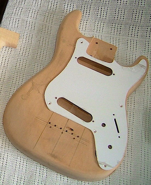 the original pickguard and the body before I dyed it.