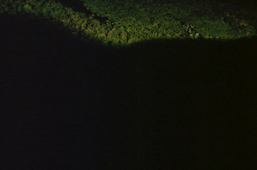 The shadow of the Kabasha Escarpment reaches eastward across its forested lower flanks as the afternoon sun sinks low; DRC.