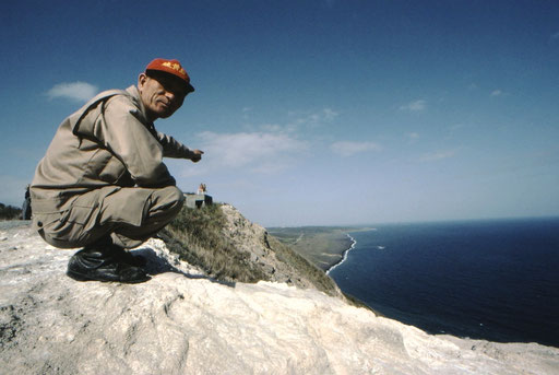A Japanese survivor points out Iwo Jima's landing beaches.