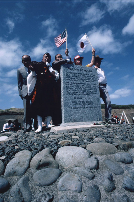 Veterans from both sides, the son of Baron Nishi Takeichi (at left, wearing a suit), and a Buddhist priest at a memorial dedication, 1985: Iwo Jima, Japan. Baron Nishi won an equestrian gold medal at the 1932 Olympics; he died in the battle here in 1945.