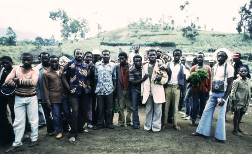 Countryside Congolese examine the 'wazungu'  -- foreigners -- who have stopped by their marketplace; Kivu, DRC.